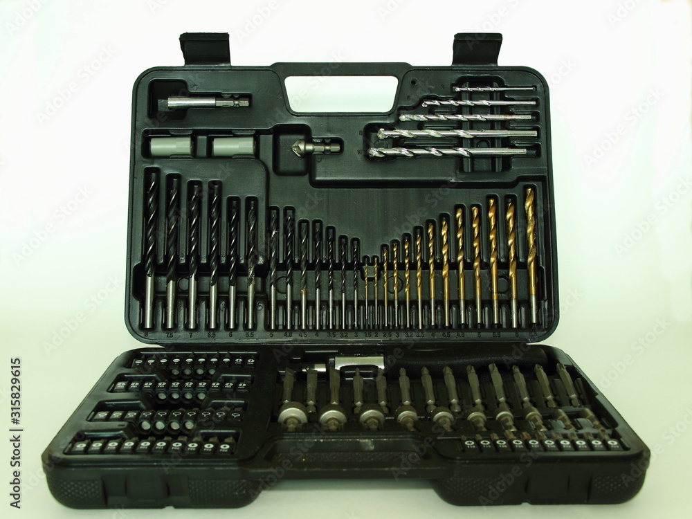 New stone, wood and metal spiral drilling bits set and screwdriver kit, DIY toolbox on white background close up New stone, wood and metal spiral drilling bits set and screwdriver kit, DIY toolbox on white background close up