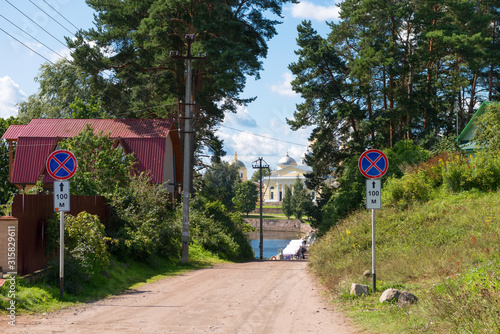 SVETLITSA, RUSSIA - AUGUST 6, 2019: The road through the village to the monastery. Nilo-Stolobenskaya Pustyn -   is situated on Stolobny Island in Lake Seliger. Tver region, Russia photo