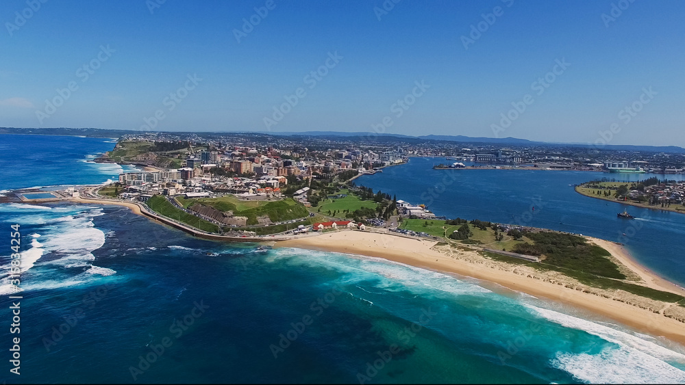 wide aerial drone shot of newcastle and nobbys head