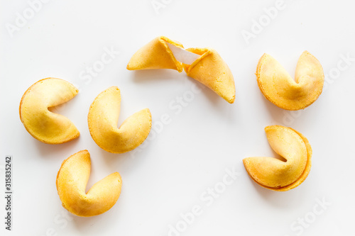 Traditional fortune cookies on white table top-down