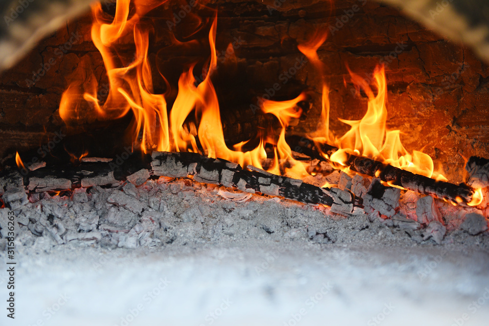 fireplace with log wood burning clay stove fire in home in the winter - fireplace room concept fireplace with log wood burning clay stove fire in home in the winter - fireplace room concept