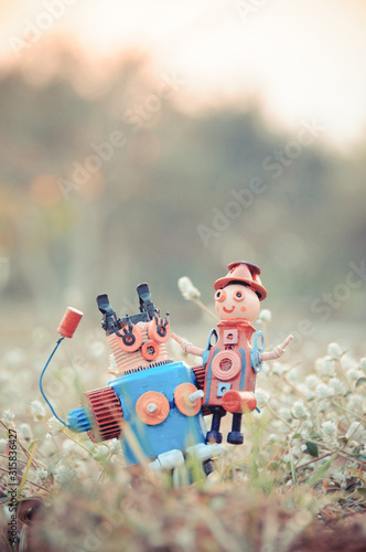 Assemblage mom and child robot sculptures in the lawn