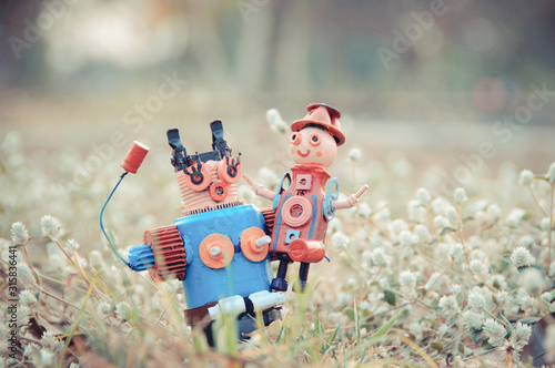 Assemblage mom and child robot sculptures in the lawn