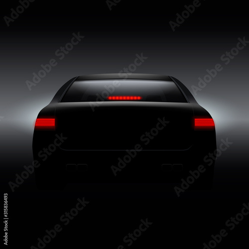 Black car with back red lights on dark background.