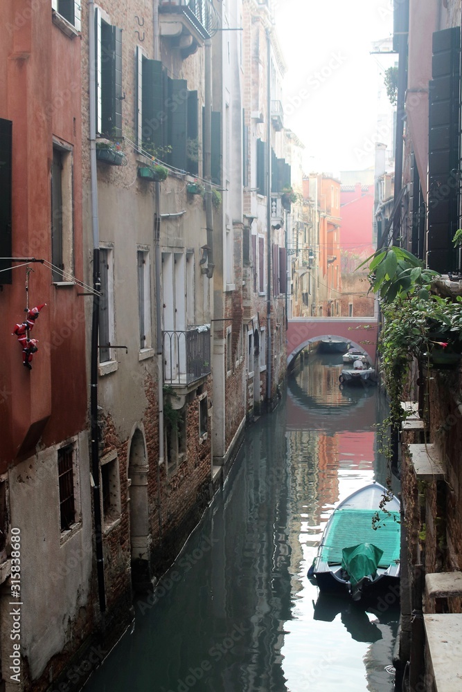Venice, Italy, December 28, 2018 evocative image of Venice canal with moored boats