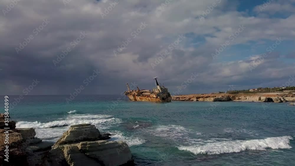 Flight over the sea and ship aground. Cargo vessel Edro III shipwrecked near rocky coast in Mediterranean sea at Paphos, Cyprus. 4K Flight over the sea and ship aground. Cargo vessel Edro III shipwrecked near rocky coast in Mediterranean sea at Paphos, Cyprus. 4K