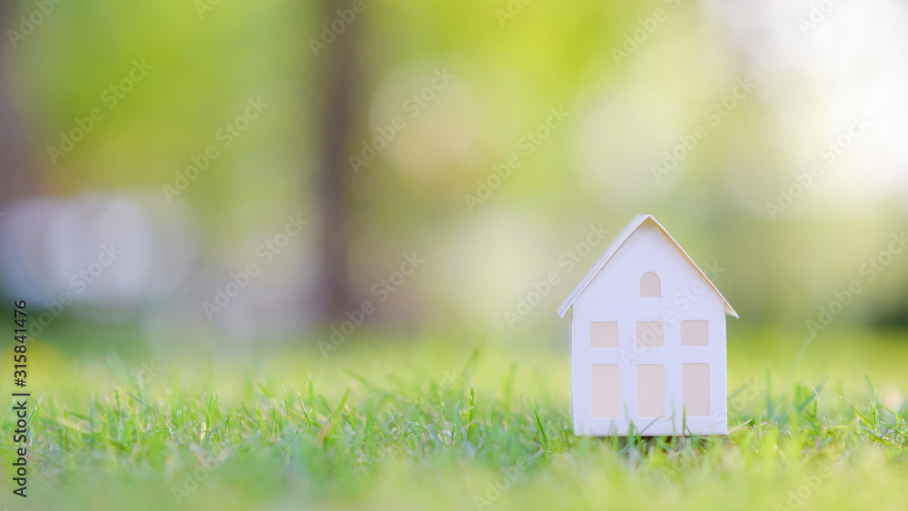 Small white house on green background Small white house on green background