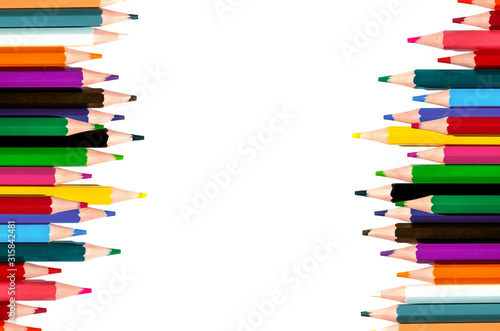 multicolored pencils on a white background. top view.