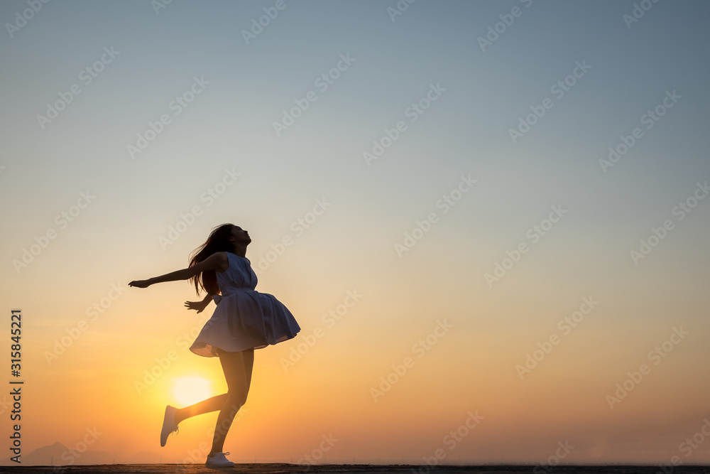 Fototapeta premium Young asia woman jumping in the sky and feeling free,happy