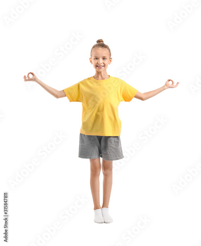 Little girl practicing yoga...
