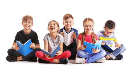 Cute little children reading books on white background