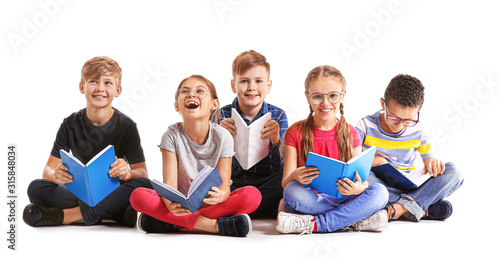Cute little children reading books on white background