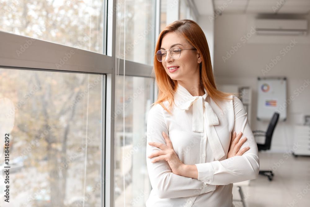 Portrait of beautiful businesswoman near window in office