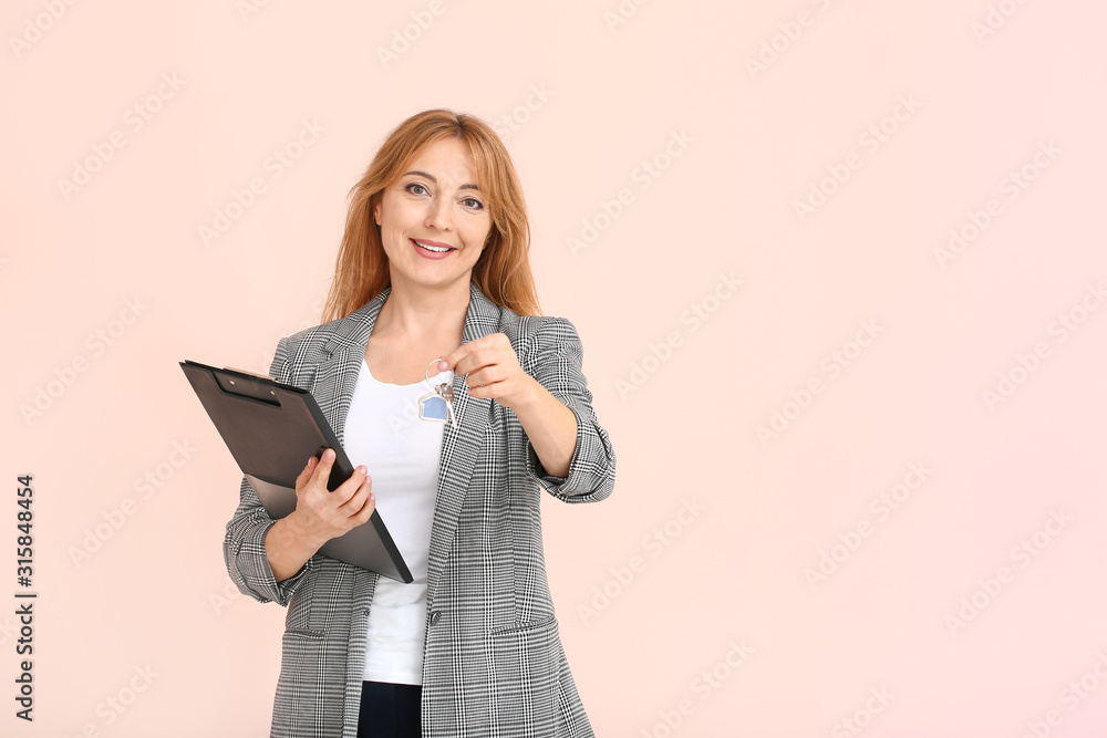 Female real estate agent with key on color background Female real estate agent with key on color background