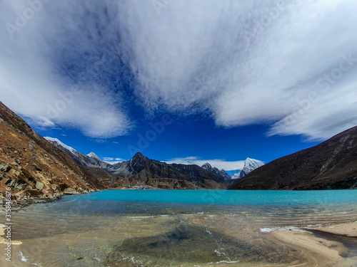 Everest base camp trek itinerary: Gokyo village, Solokhumbu, Nepal. Picturesque view on famous Dudh Pokhari or Gokyo lake with marvellous turquoise water. photo