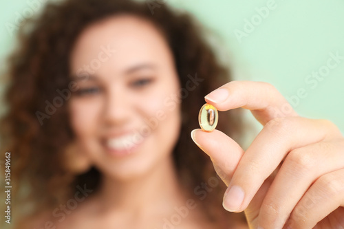 Young woman with fish oil, ...