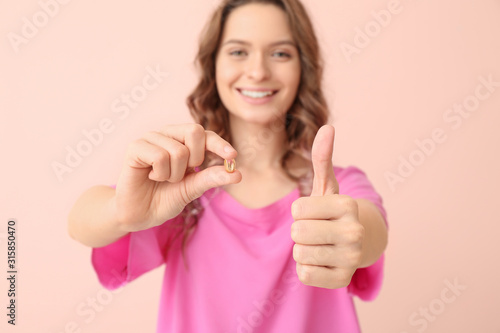 Young woman with fish oil o...
