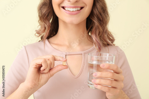 Young woman with fish oil o...