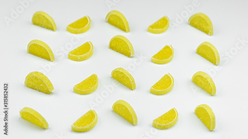 Marmalade lemon slices, bright, on a yellow background.