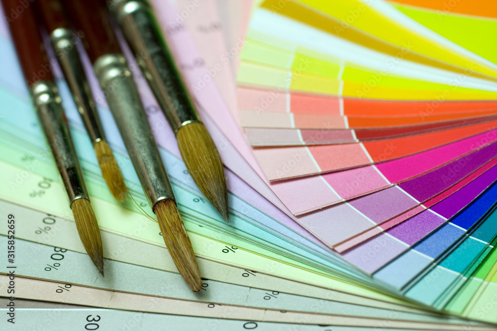 Fototapeta premium Brushes on a color print of pantone statistics offset scale