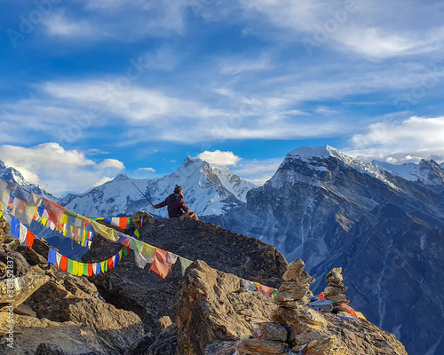 Nepal - November 2019: A trekker sitting at the top of Gokyo Ri and making selfie. Picturesque mountain view from Gokyo Ri at sunrise. Trekking in Solokhumbu, Nepal, Himalayas.