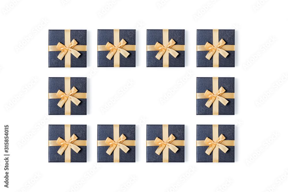 Holiday card. Grey gift boxes with gold bow on isolated white background. Flat lay, top view, copy space.