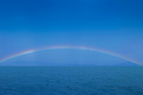 view of raining with rainbow in the sea, Trang sea, south of Thailand.