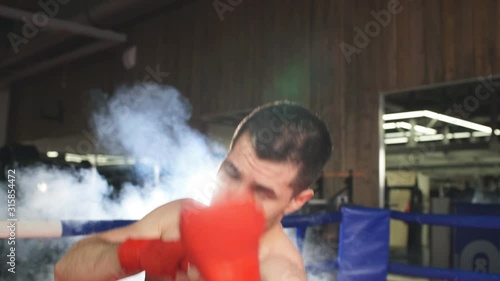 Boxer conducts sparring in the ring. Male boxer sends his opponent to knockout