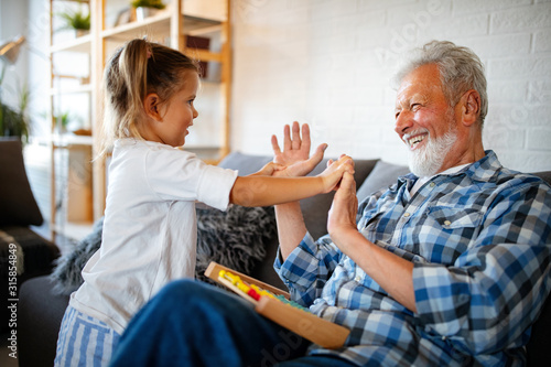 Grandparent playing and having fun with their granddaughter