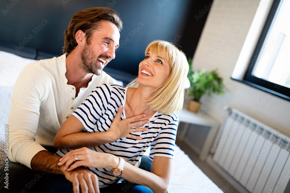 Fototapeta premium Beautiful young couple hugging and smiling together