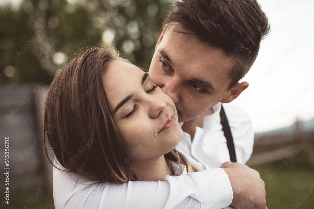 loving couple walking, having fun, hugging and kissing in the mountains loving couple walking, having fun, hugging and kissing in the mountains