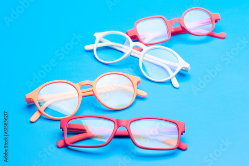 Colored glasses on plain background  modern glasses for fashion.
