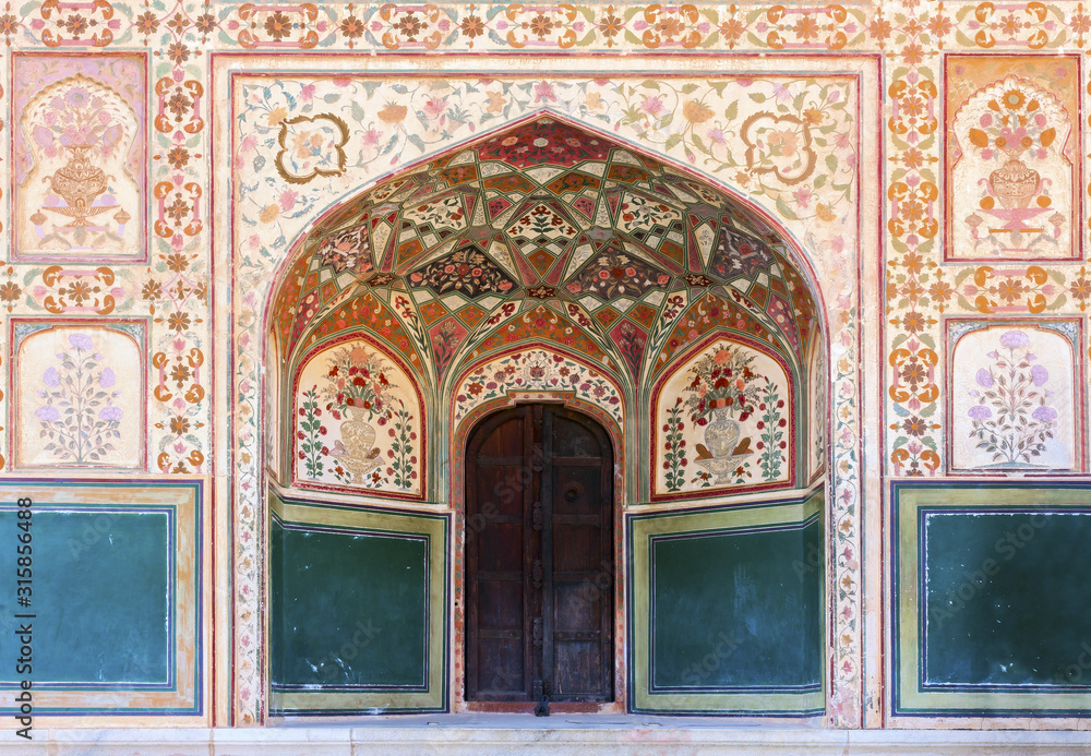 Stunning facade of Ganesh Pol entrance in Amber Fort Palace, Jaipur, Rajasthan, India