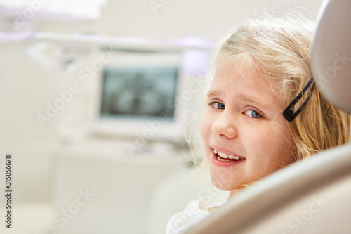 Smiling girl at the child dentist