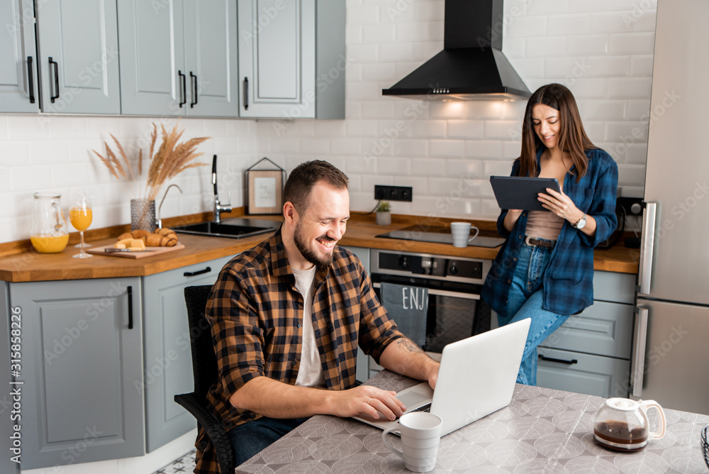 Caucasian guy with a girl in the kitchen