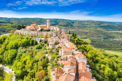 Beautiful old town of Motovun, stone houses and church tower bell, romantic architecture in Istria, Croatia, aerial view from drone