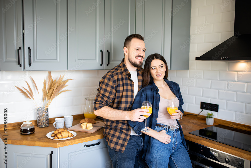 Attractive young guy and girl in the kitchen Attractive young guy and girl in the kitchen