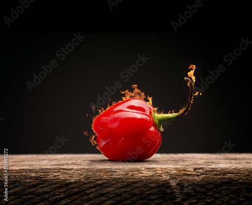 Cuadro en lienzo Hot and spicy Habanero chili with flames