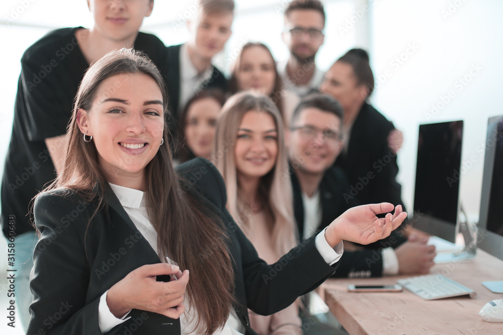 young business woman on the background of her colleagues young business woman on the background of her colleagues