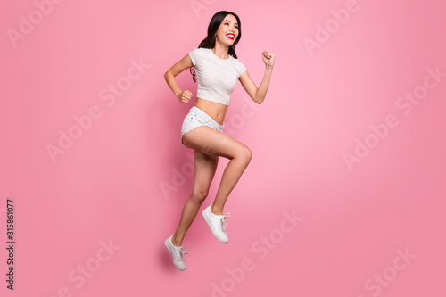 Full length body size view of her she nice attractive lovely charming winsome glamorous cheerful cheery wavy-haired girl jumping running fast motion isolated over pink pastel color background