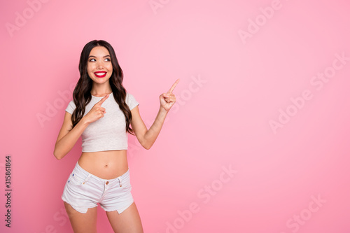 Portrait of her she nice-looking attractive lovable lovely gorgeous cheerful cheery slender slim fit thin wavy-haired girl pointing copy space new novelty isolated over pink pastel color background