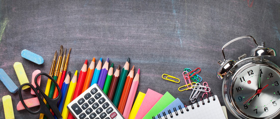 School supplies on blackboard background