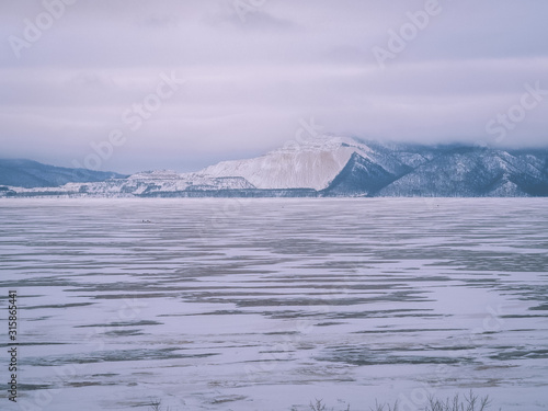 Icy landscape, blue mountains in the distance, icy desert, winter nature, ice on the river