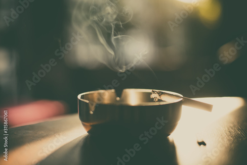 Burning cigarette in an ashtray