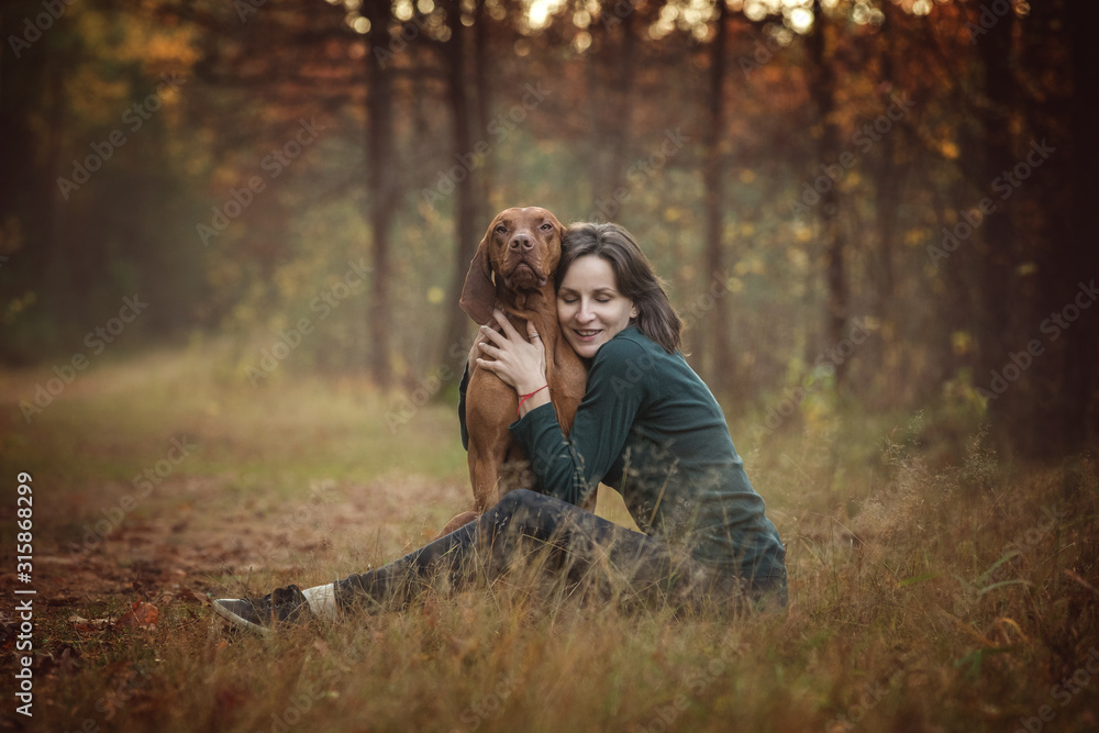 Happy young woman hugging a dog. Happy young woman hugging a dog.