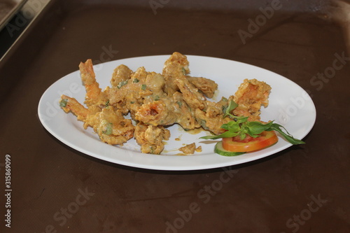 Fried shrimp with salted egg sauce and chili on top
