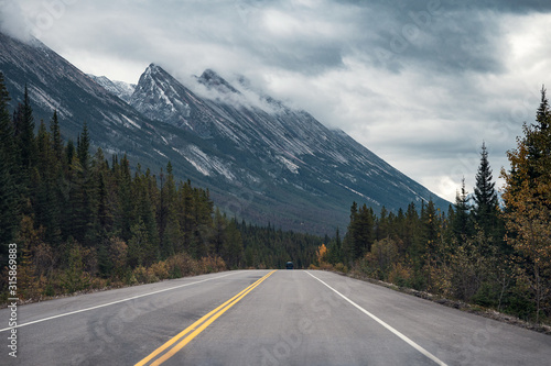 Road trip with Rocky mountains in autumn forest on gloomy at Banff national park