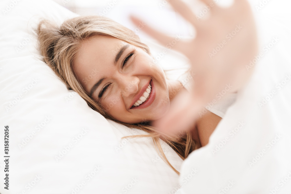 Photo of joyful caucasian woman laughing and looking at camera Photo of joyful caucasian woman laughing and looking at camera