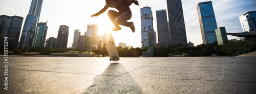 Skateboarder skateboarding at sunset city photo