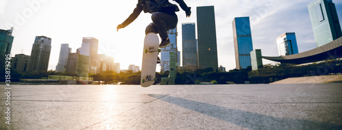 Skateboarder skateboarding at sunset city photo